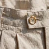 pleated linen trousers men beige corozo button waistband detail