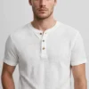 Man wearing gold minimalist watch with white waffle Henley t-shirt - old money style - AURA FASHION